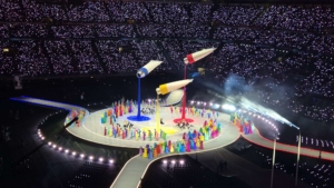 Giant paint tubes spilling cascading swathes of fabric across the stage